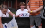 Photo of people gathering yellow squash
